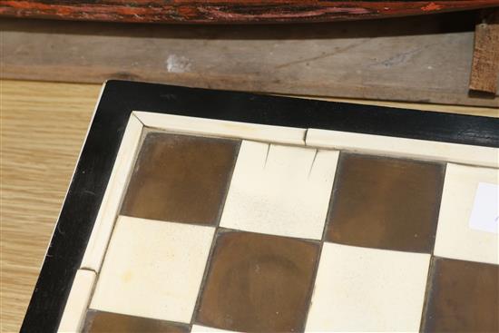 A 1930s ivory and tortoiseshell chess board and a 19th century ivory chess and draughts sets